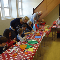 Children and adults helping with craft session