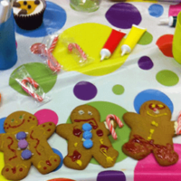 Close up of table and 3 decorated gingerbread men
