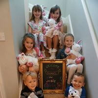 6 children sat on stairs with their cuddly bears