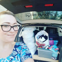 Selfie of Charlotte with car boot packed with crafts ready for party at home