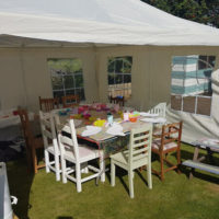 Garden party table set up with crafts in marquee