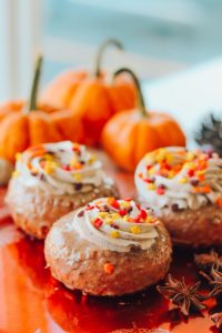 pumpkin muffins in foreground with orange pumkins in background