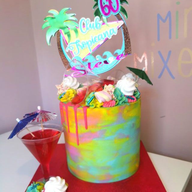 Tall buttercream multicoloured Club Tropicana themed 60th birthday cake